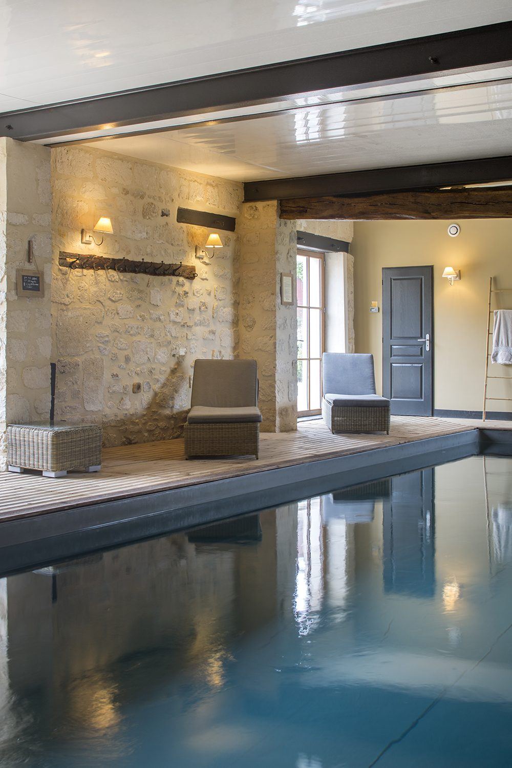 La piscine intérieure chauffée, sous charpente et murs de pierre